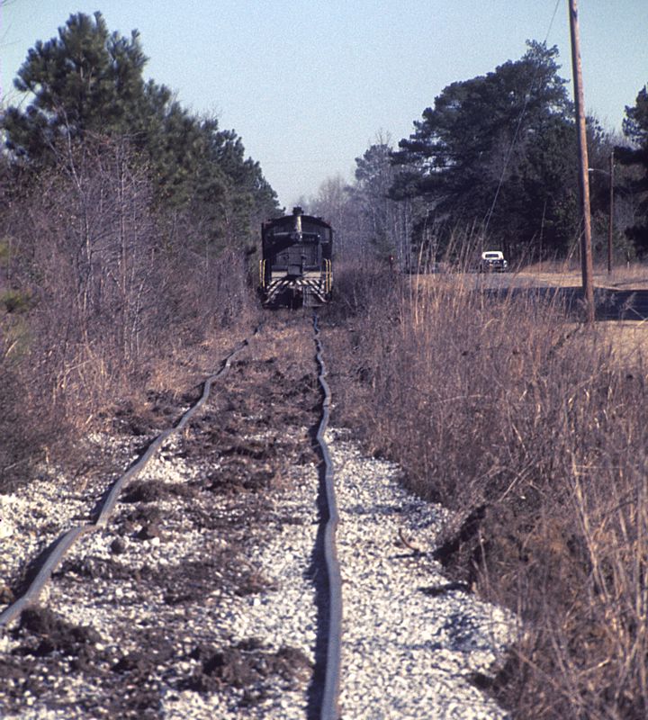 Southern Railway engine 1004 shoving log cars north in Wadley, GA